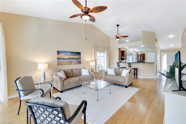Open great room with volume ceilings and wood floors
