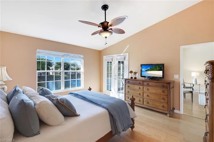 Primary suite features French doors opening to the sunroom and a spacious walk-in closet.