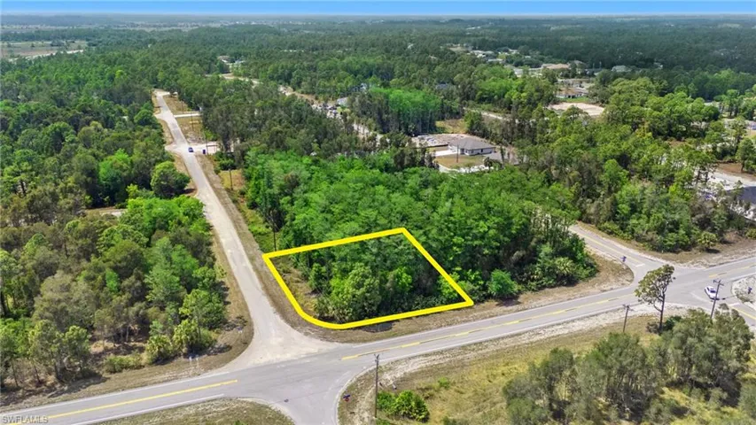 Birds eye view of property featuring a view of trees