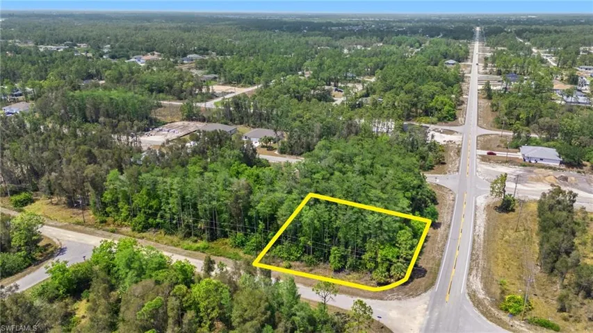 Birds eye view of property with a wooded view