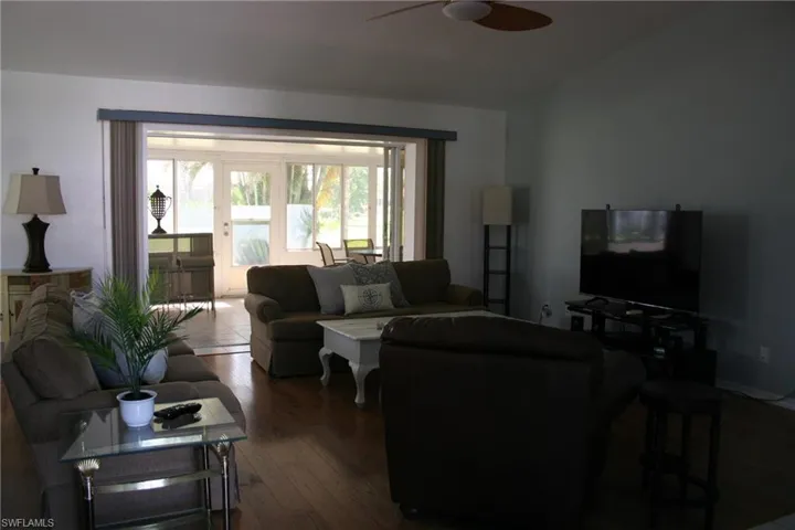 Living area featuring wood finished floors and a ceiling fan
