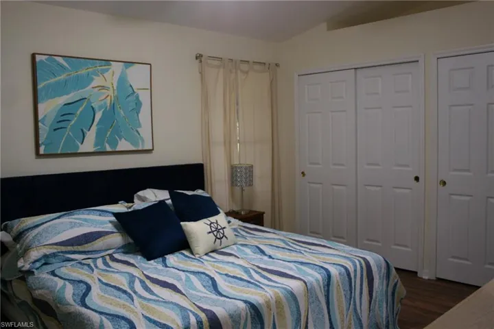 Bedroom with a closet and wood finished floors