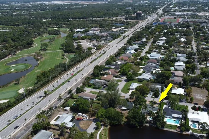 View of property location with a highway, nearby suburban area, a large body of water, and a local golf course