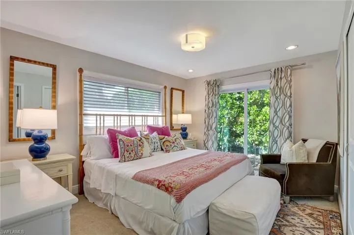 Guest bedroom featuring light colored carpet, baseboards, and recessed lighting