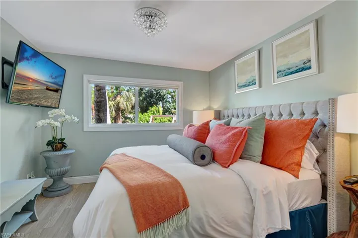 Main bedroom with wood finished floors and baseboards