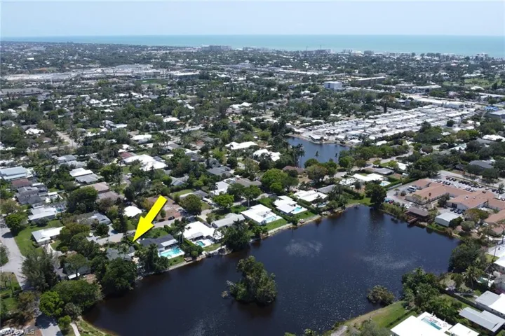 Aerial view of property's location featuring a large body of water