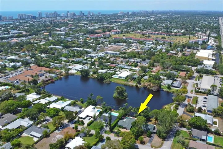 Aerial view of property's location featuring nearby urban area and a nearby body of water
