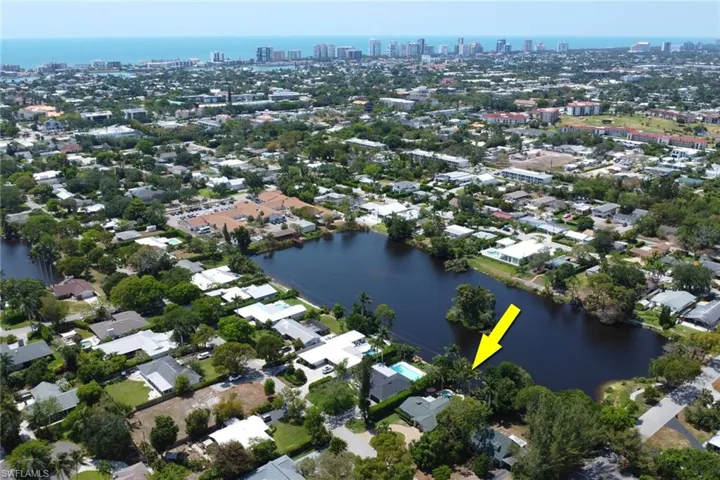 Aerial overview of property's location with nearby urban area and a large body of water
