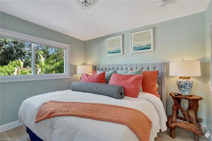 Main bedroom with baseboards and light wood-style flooring
