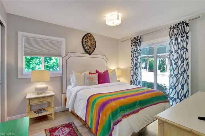 Guest bedroom featuring wood finished floors