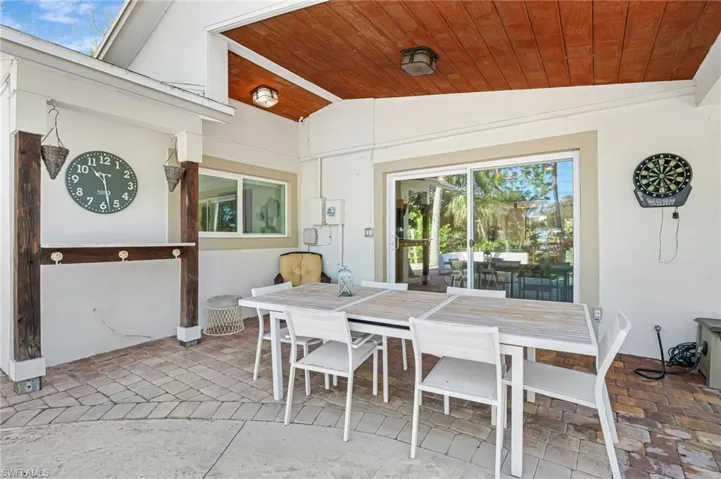Patio dining room with vaulted ceiling and wooden ceiling