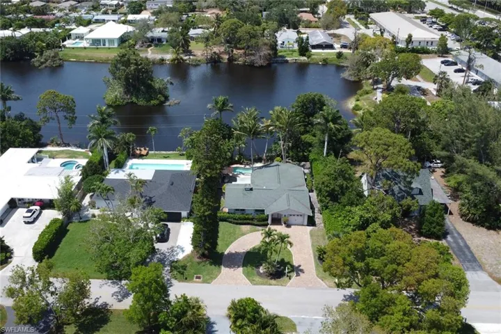 View of property location featuring a large body of water and nearby suburban area