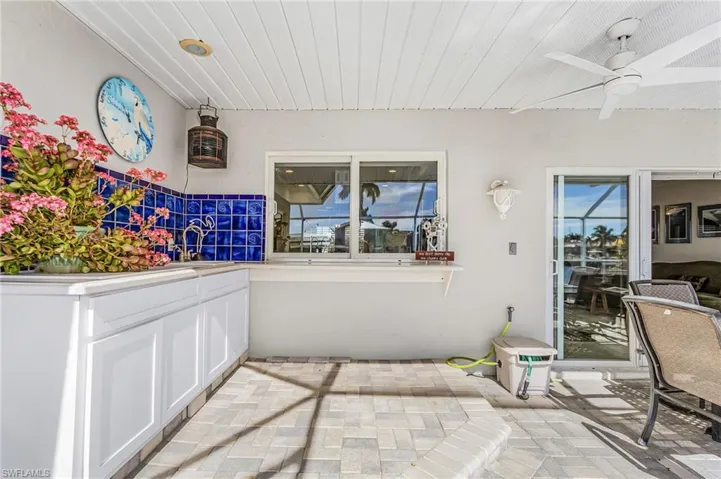 View of patio / terrace featuring ceiling fan and a sink