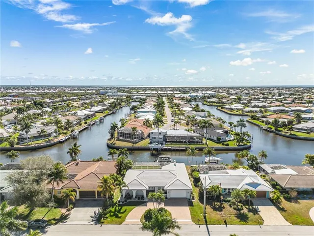 Aerial view of residential area featuring a nearby body of water