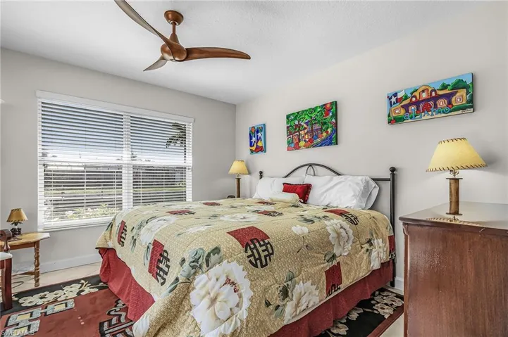 Bedroom featuring ceiling fan and baseboards