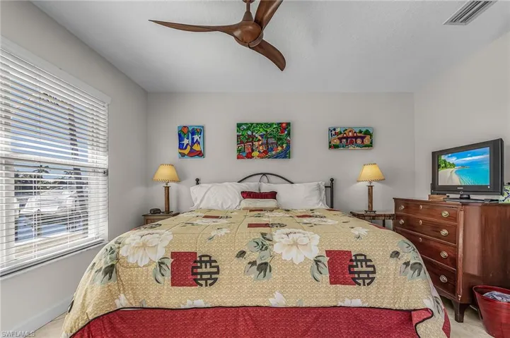 Bedroom featuring ceiling fan and baseboards