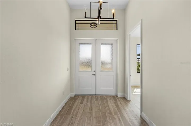 Entryway featuring a notable chandelier and light hardwood / wood-style flooring