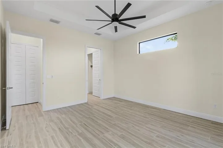 Unfurnished bedroom featuring light hardwood / wood-style flooring and ceiling fan