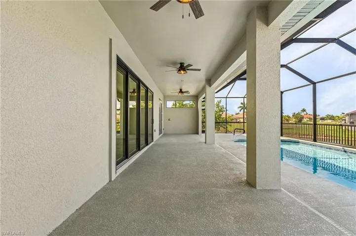 View of patio with a lanai, a fenced in pool, and ceiling fan