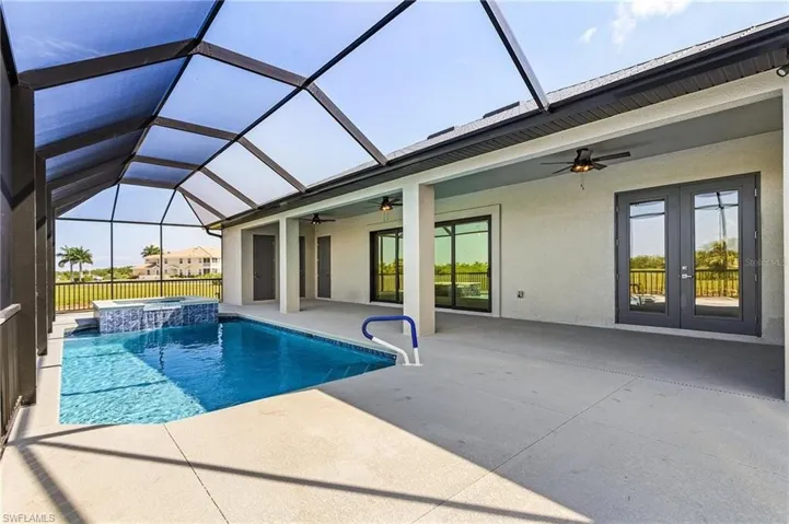 View of swimming pool featuring a lanai, a patio, an in ground hot tub, and ceiling fan