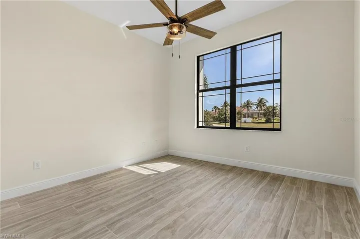 Empty room featuring ceiling fan and light hardwood / wood-style flooring