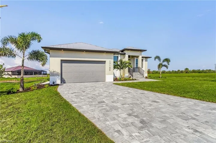 View of front of home featuring a garage and a front lawn