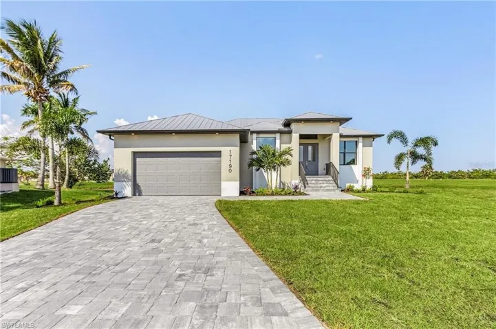 Prairie-style home featuring a garage and a front yard