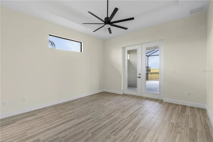 Empty room with light hardwood / wood-style flooring, french doors, and ceiling fan