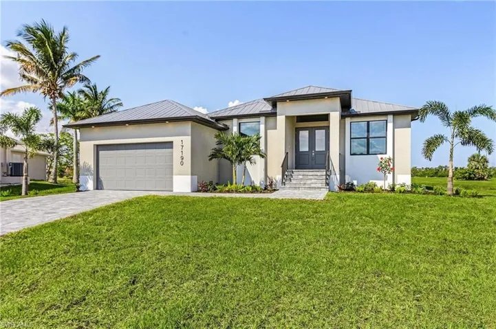 View of front facade with a garage and a front lawn