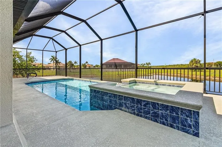 View of swimming pool with an in ground hot tub, a lanai, and a patio area