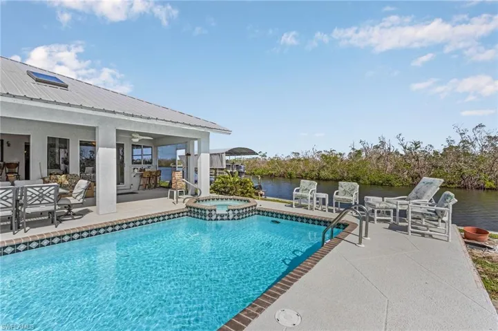 Pool, spill-over spa, and covered lanai.