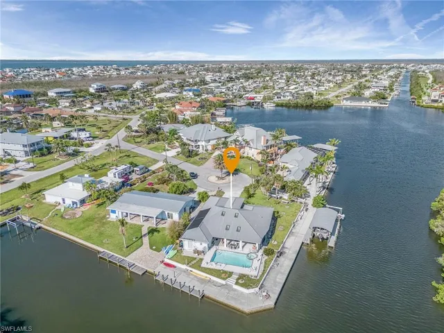Aerial view of this waterfront home looking SW toward San Carlos Bay and Sanibel.