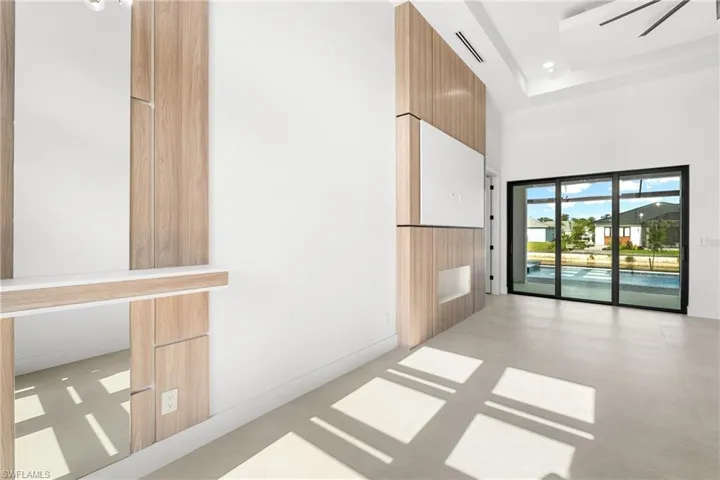 Spacious interior with high ceilings and light-toned tile flooring