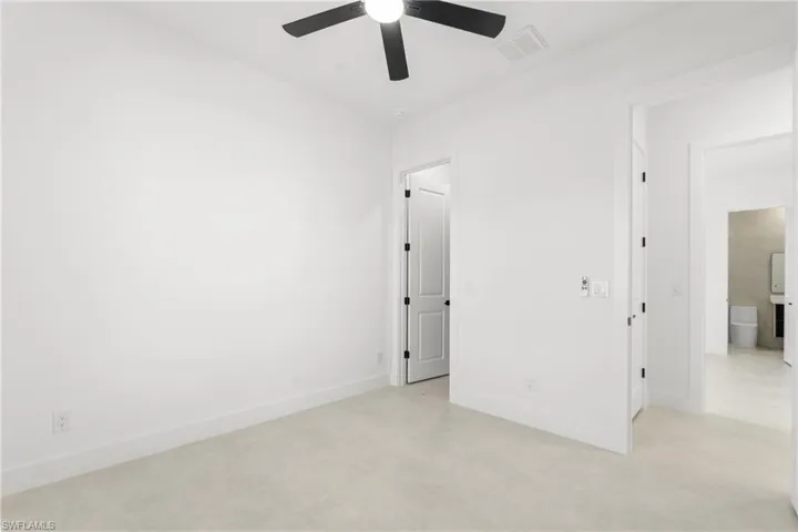 Neutral toned carpeting complementing crisp white walls and baseboards