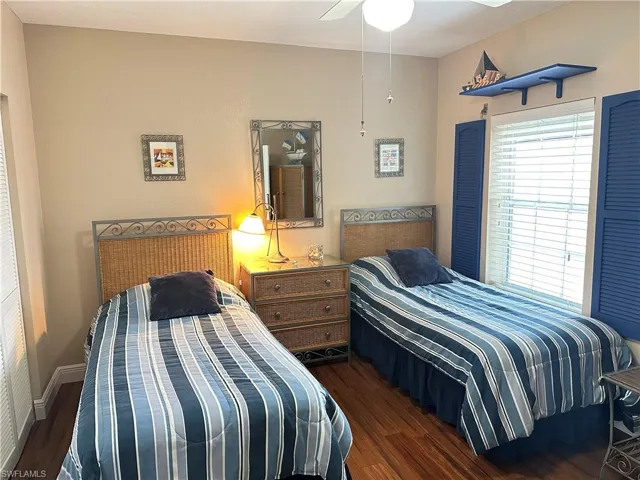 Room featuring wood-finish flooring and a ceiling fan