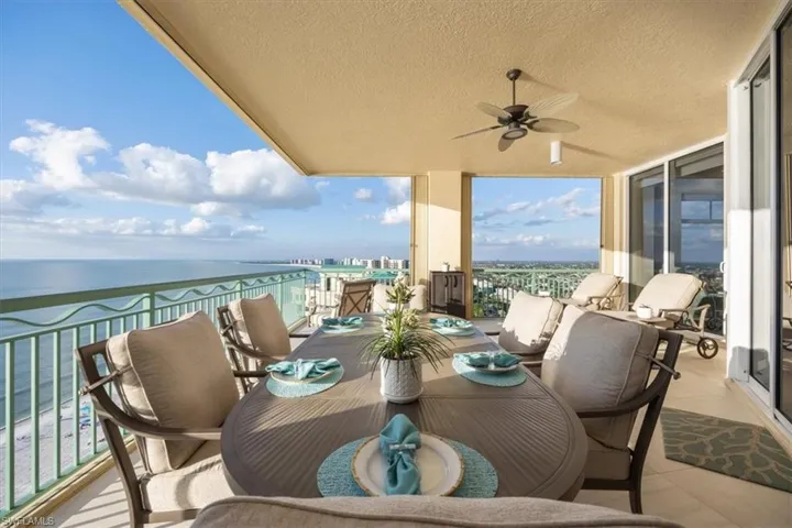 Balcony featuring a water view and ceiling fan