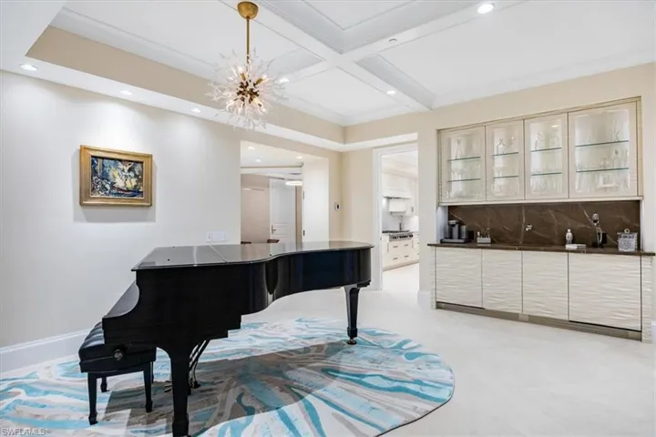 Miscellaneous room featuring a chandelier, beam ceiling, and coffered ceiling