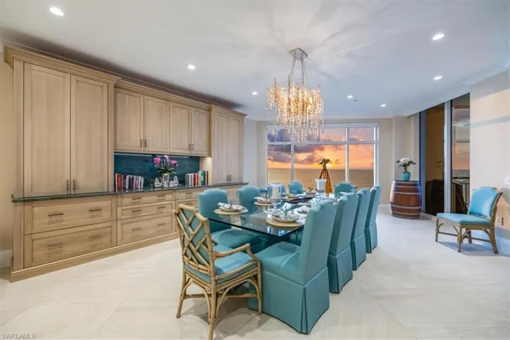Dining space featuring a chandelier, light tile patterned floors, and ornamental molding