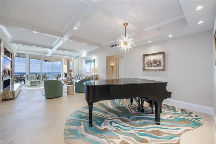 Miscellaneous room featuring crown molding, beamed ceiling, a chandelier, and coffered ceiling