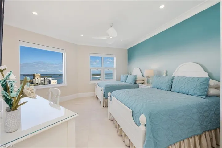 Bedroom with crown molding and ceiling fan