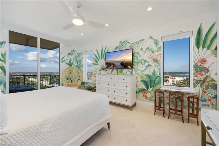 Bedroom with ceiling fan, access to outside, and multiple windows