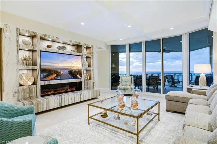 Living room featuring a wealth of natural light and a wall of windows