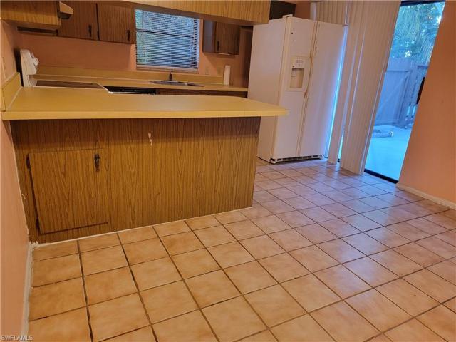 View from dining room into kitchen, slider to patio