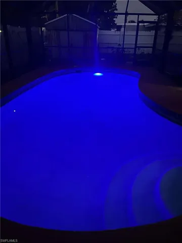 Pool with a lanai, a patio area, and a fenced backyard
