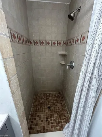 Bathroom featuring a shower with curtain