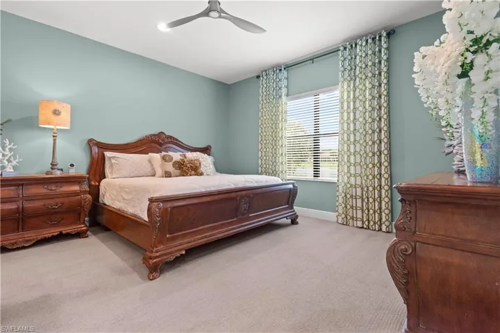 Primary bedroom with plush carpeting
