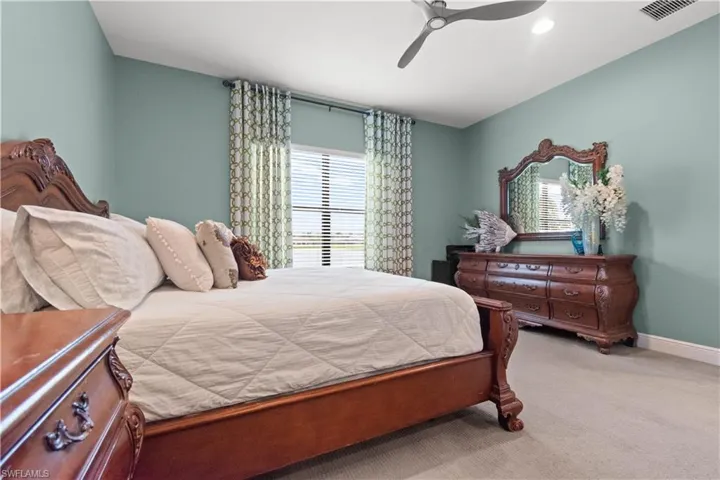 Spacious bedroom featuring a large window with water view
