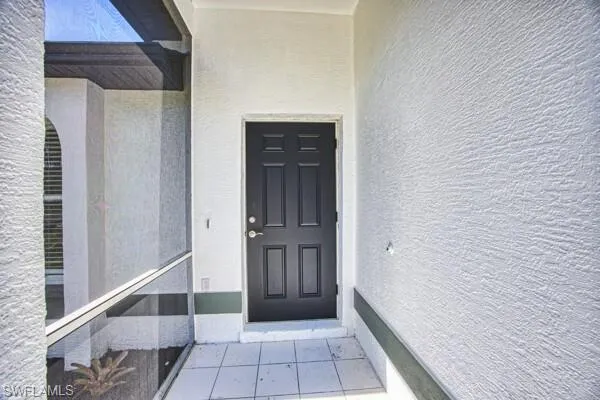 Property entrance with stucco siding