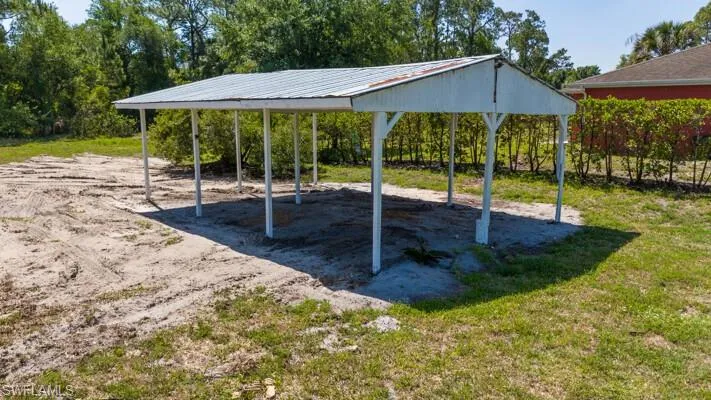 View of property's community featuring a carport and a yard