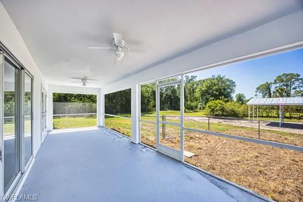 Oversized screened lanai with a ceiling fan and plenty of natural light